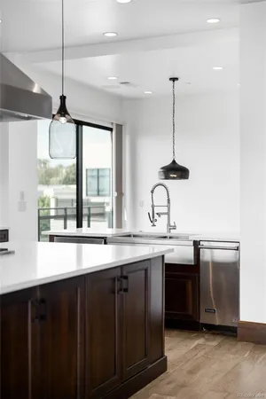 a kitchen with stainless steel appliances granite countertop a sink a window and cabinets