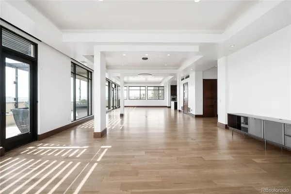a view of an entryway with wooden floor