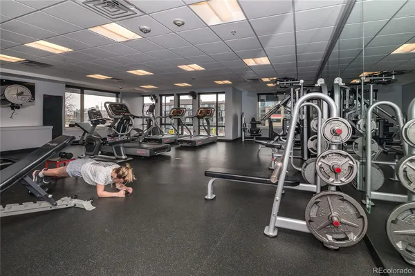 a view of an empty room with kitchen view and a window