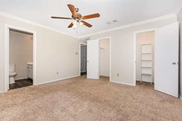 a view of a livingroom with a ceiling fan & entryway