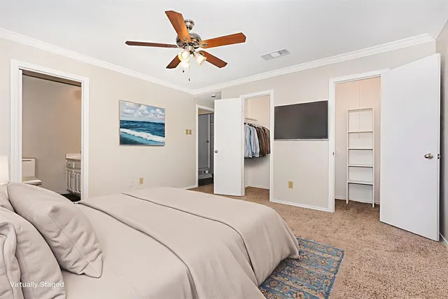 a bedroom with a large bed a flat tv screen and closet