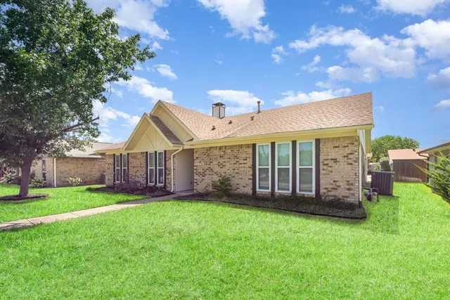 a view of a house with a yard and porch