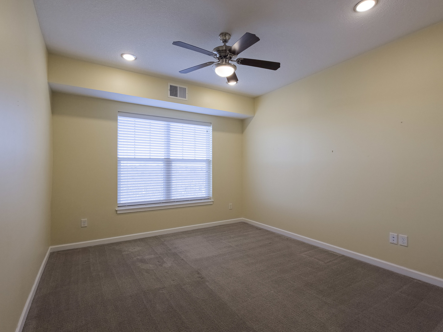 2592 Middle Road, Unit 313 Bettendorf, IA 52722 - Photo 29 of 52 an empty room with a ceiling fan and window