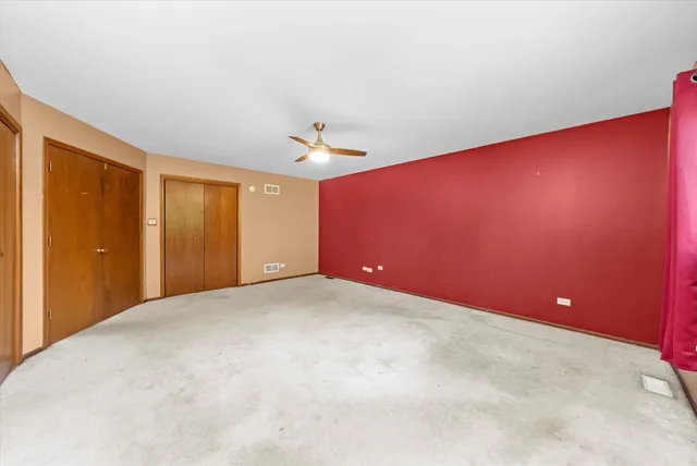 a view of an empty room with closet area