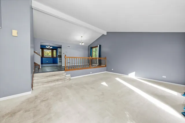 a view of an empty room with stairs