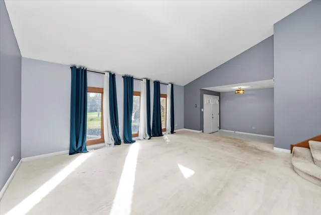 a view of a big room with windows and entryway