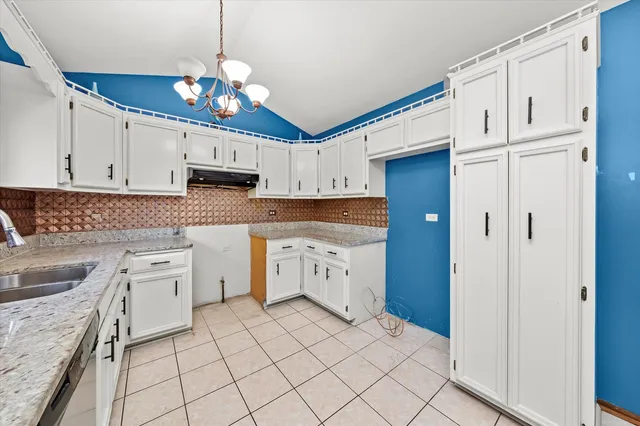 a kitchen with cabinets appliances and a window