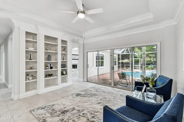 a view of a dining room with furniture and chandelier