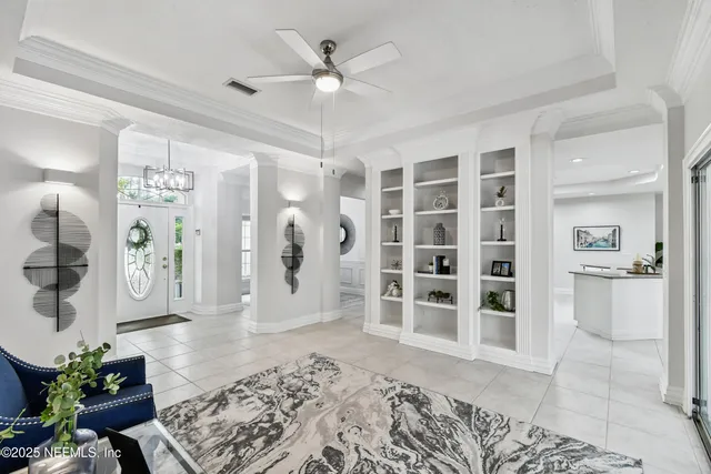 a view of a dining room with furniture a chandelier and wooden floor