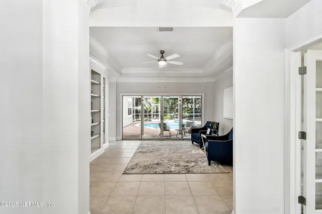 a kitchen with stainless steel appliances a sink a stove a refrigerator cabinets and chairs