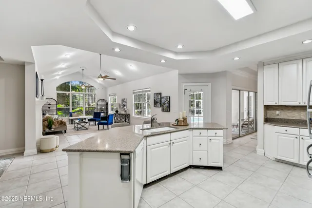 a spacious bedroom with a bed and a large window