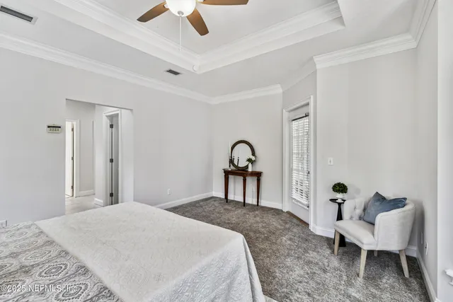 a bedroom with a bed lamp and a window