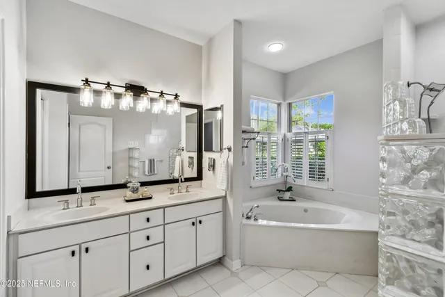 a bathroom with a granite countertop sink a toilet and a mirror