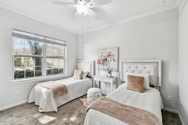 an empty room with a window and ceiling fan