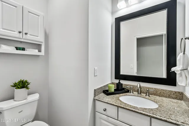 a view of a house with a big yard and palm trees