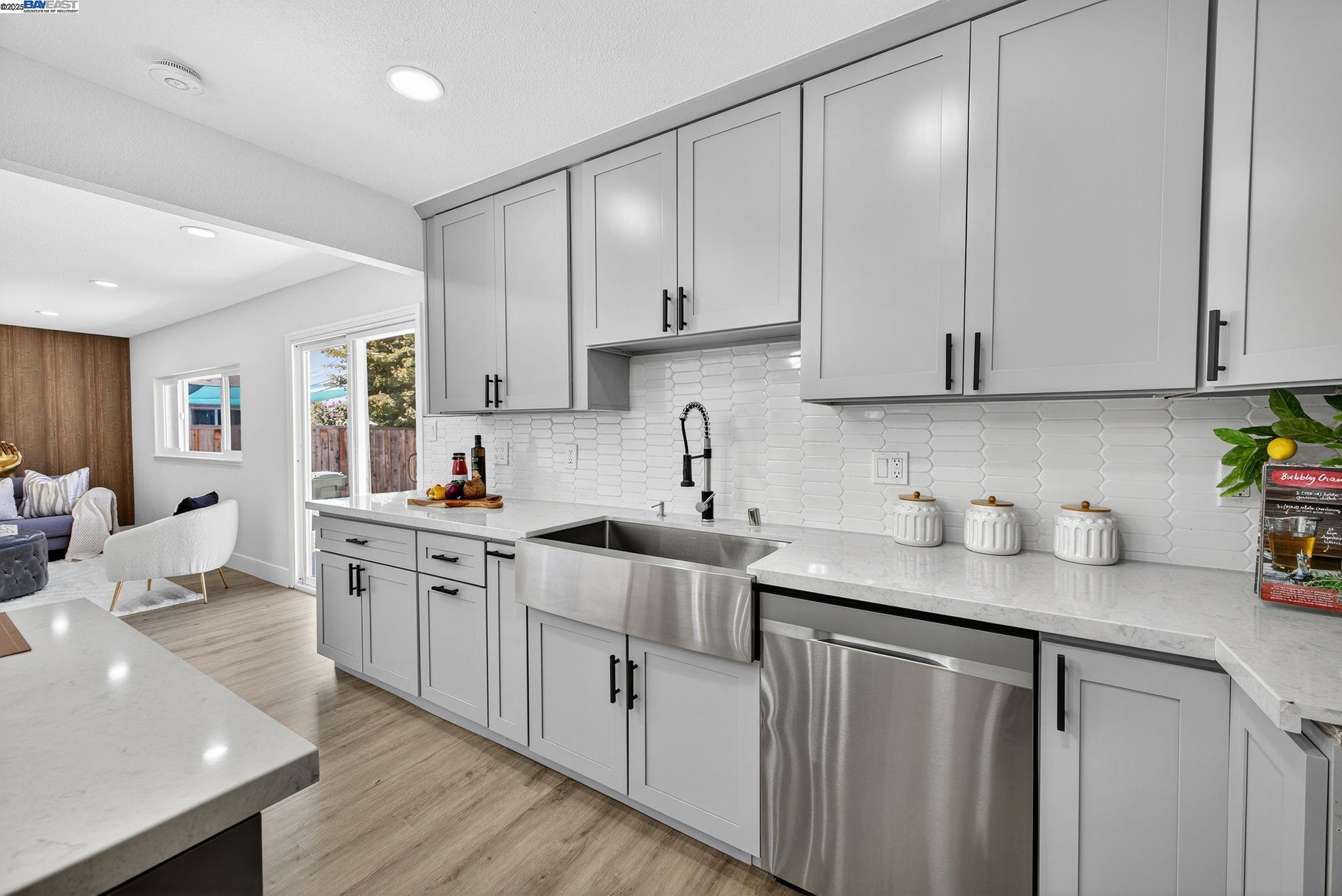 4403 Burke Way Fremont, CA 94536 - Photo 11 of 58 a kitchen with stainless steel appliances granite countertop a sink stove and cabinets