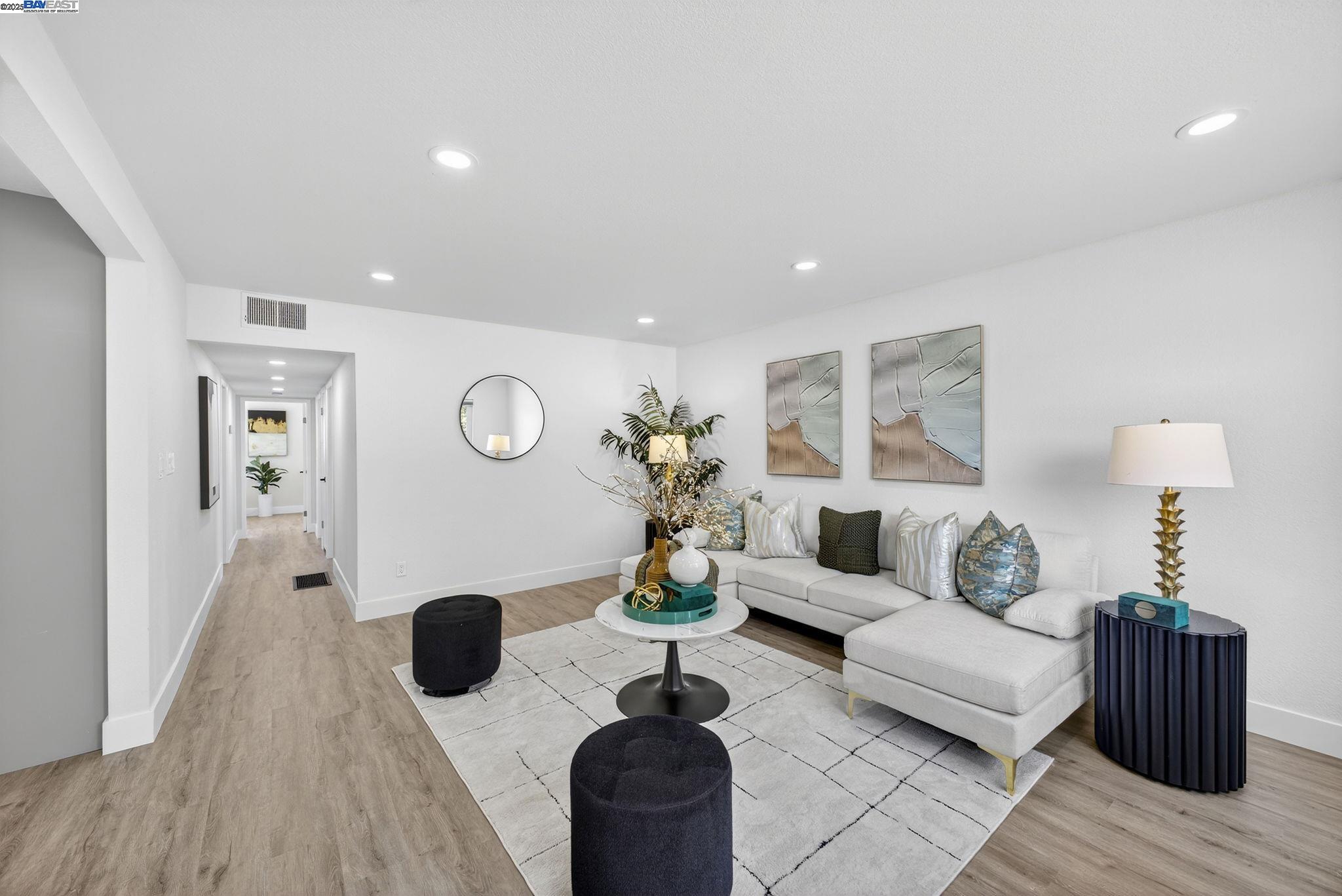 4403 Burke Way Fremont, CA 94536 - Photo 16 of 58 a living room with furniture a chandelier and a table