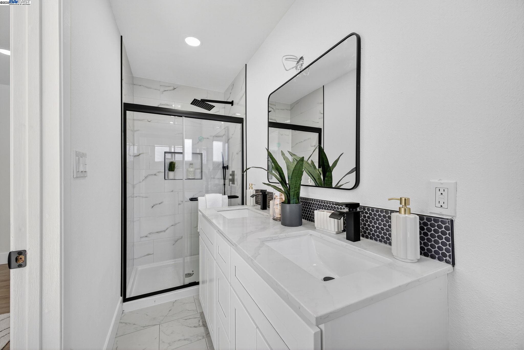 4403 Burke Way Fremont, CA 94536 - Photo 27 of 58 a bathroom with a sink a mirror and a shower
