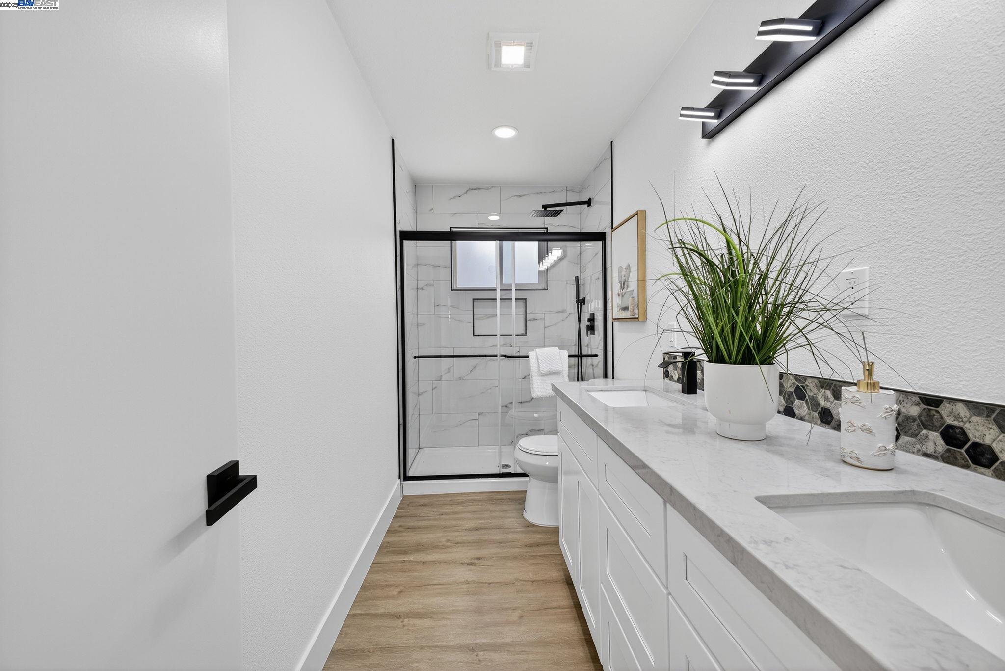 4403 Burke Way Fremont, CA 94536 - Photo 30 of 58 a bathroom with a sink a mirror and a potted plant