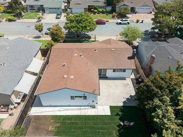 an aerial view of a house with a yard and garden