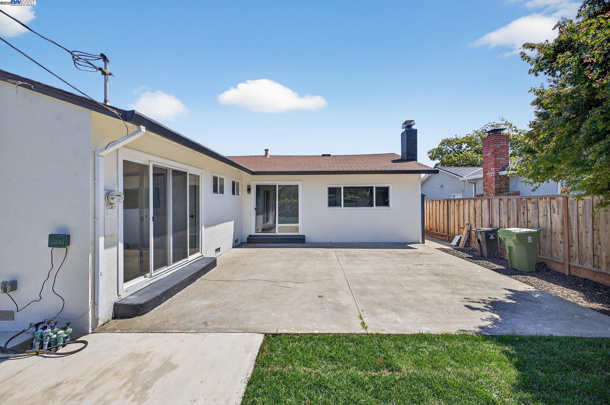 4403 Burke Way Fremont, CA 94536 - Photo 39 of 58 a front view of a house with a yard and potted plants