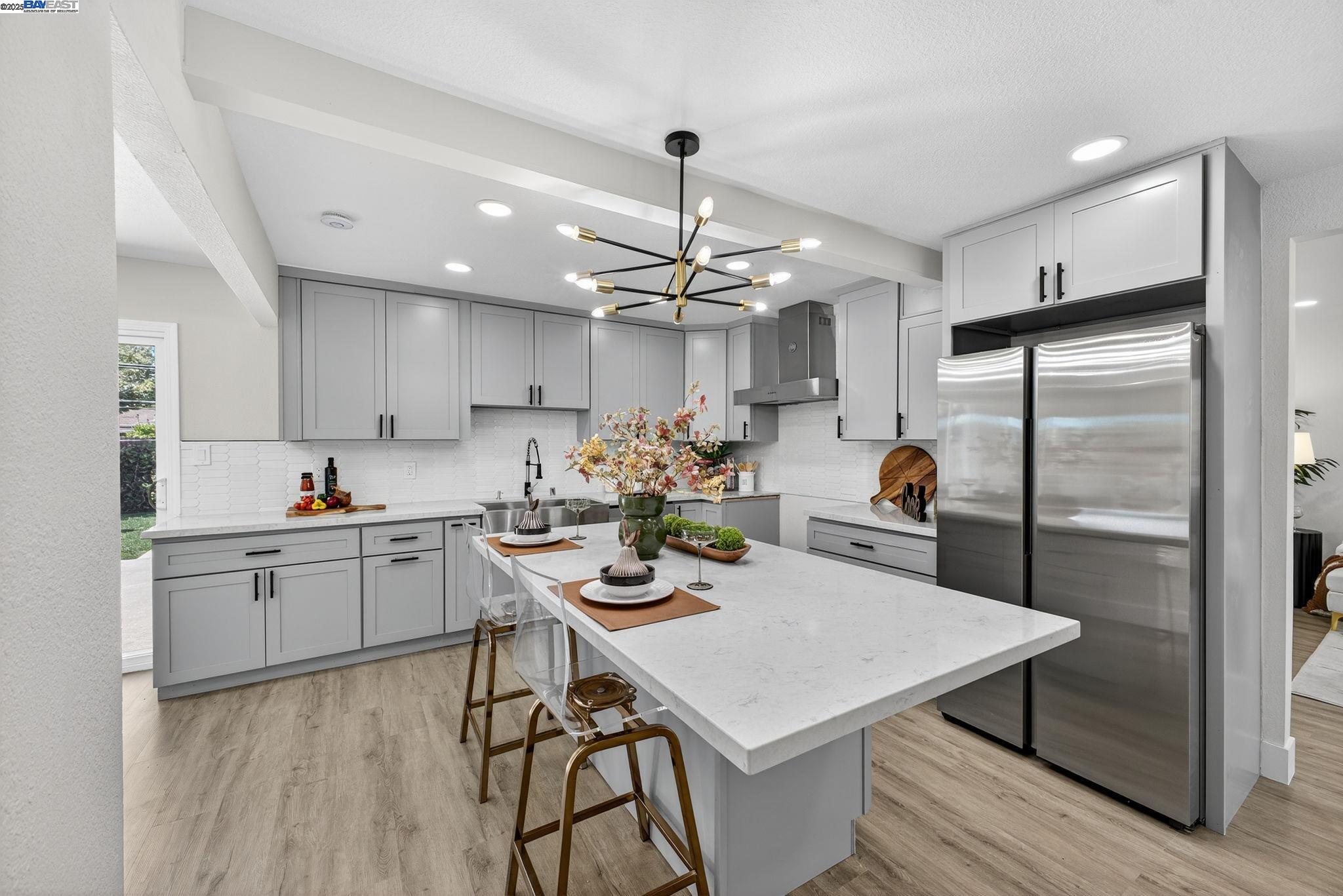 4403 Burke Way Fremont, CA 94536 - Photo 6 of 58 a kitchen with a dining table cabinets appliances and wooden floor