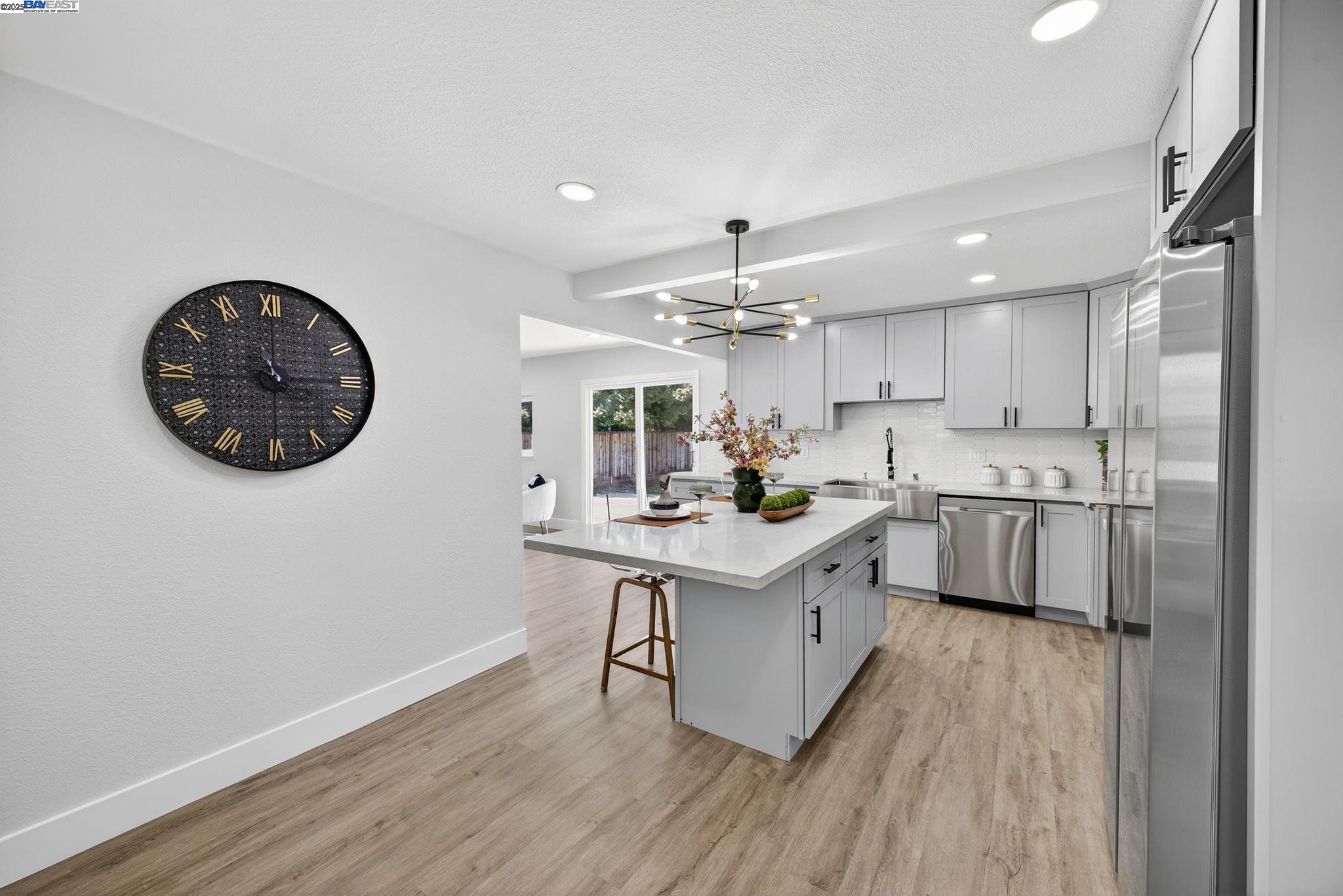 4403 Burke Way Fremont, CA 94536 - Photo 7 of 58 a kitchen with a sink cabinets and wooden floor