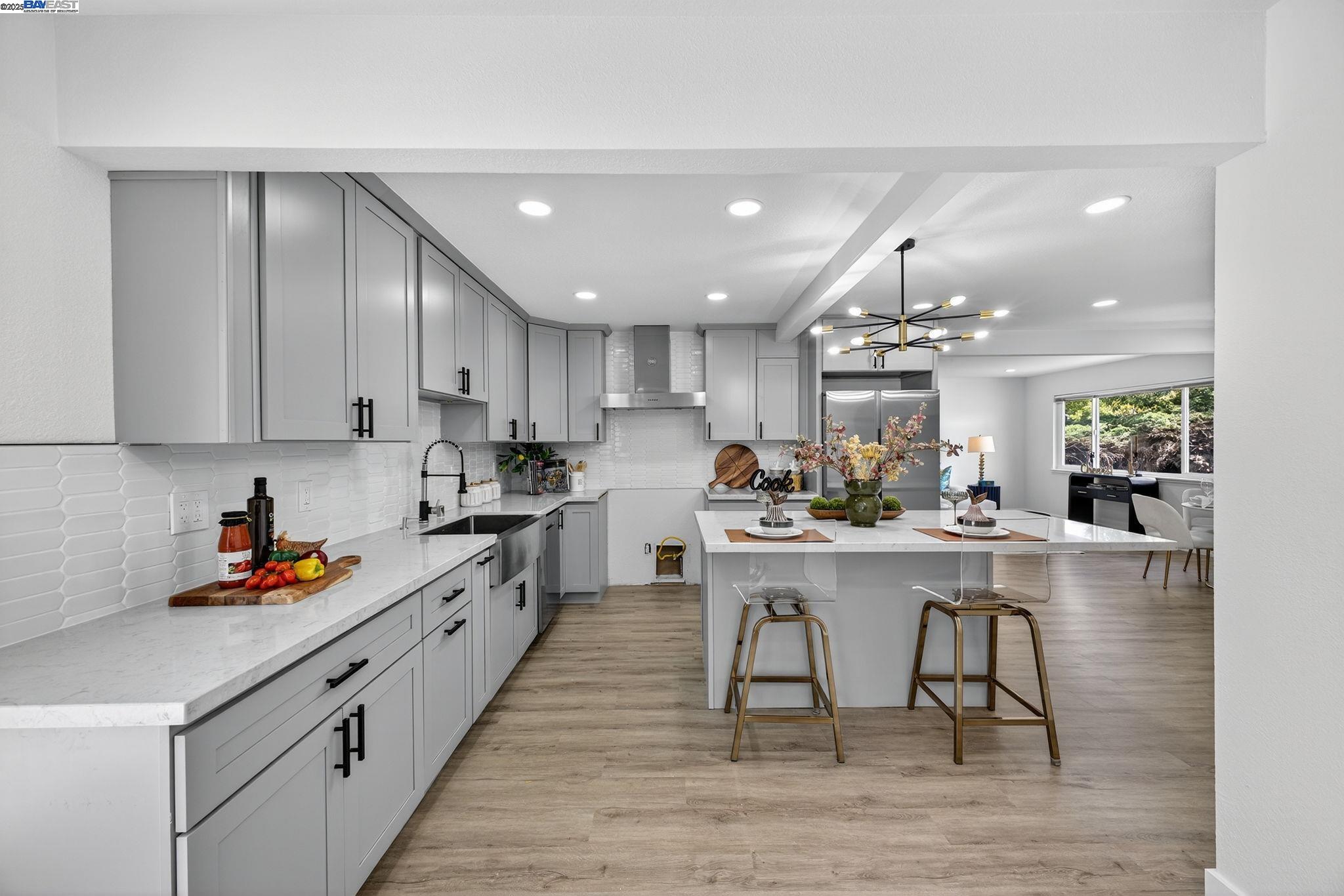 4403 Burke Way Fremont, CA 94536 - Photo 10 of 58 a kitchen with stainless steel appliances granite countertop a table chairs sink and cabinets