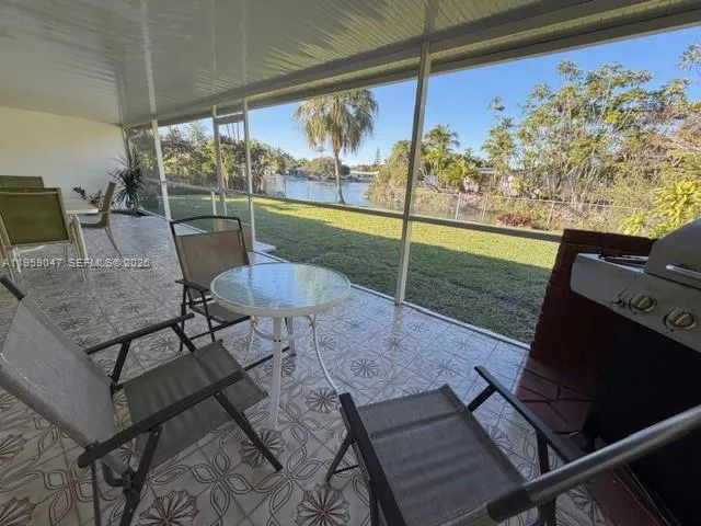 a view of a porch with furniture and garden