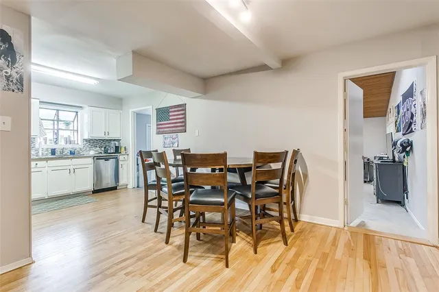 a view of a dining room with furniture and wooden floor