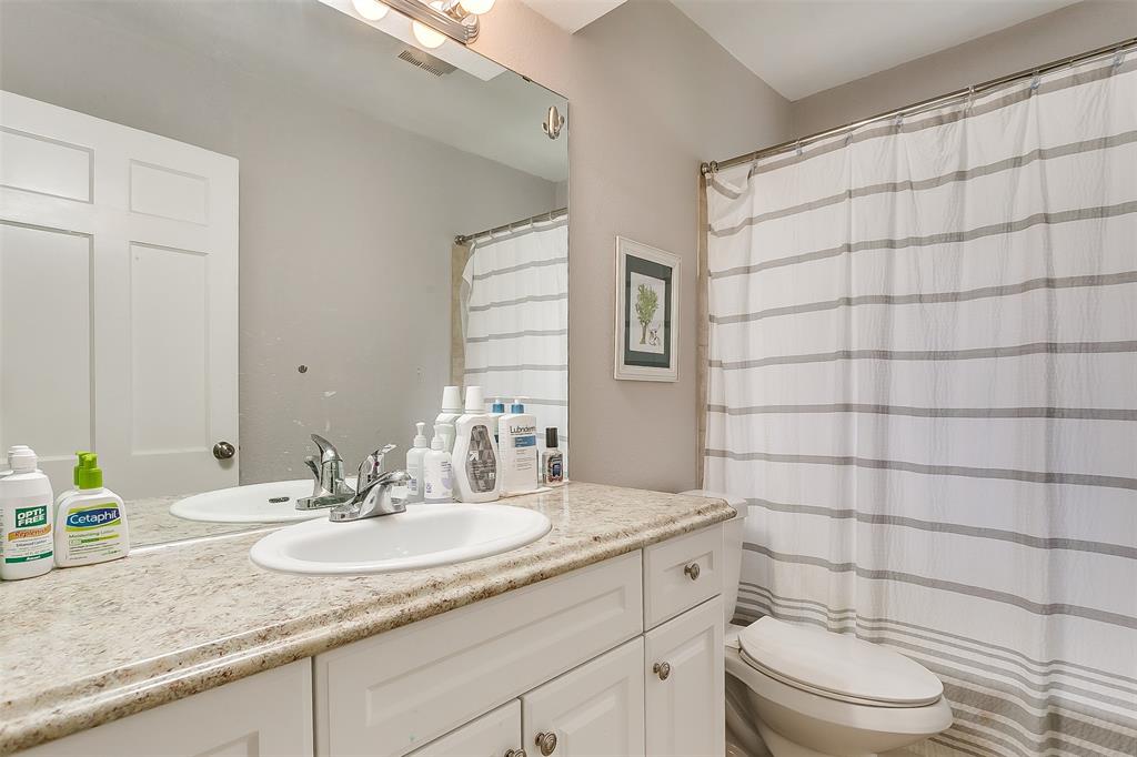 3567 Norfolk Road Fort Worth, TX 76109 - Photo 16 of 21 a bathroom with a granite countertop sink a toilet and a mirror