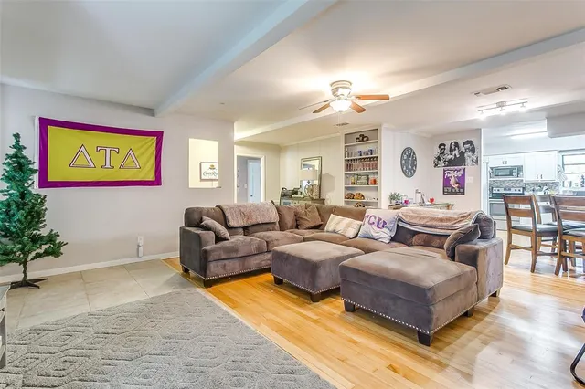 a living room with furniture and a chandelier