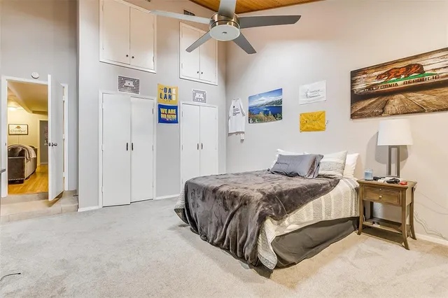 a spacious bedroom with a bed and wall painting