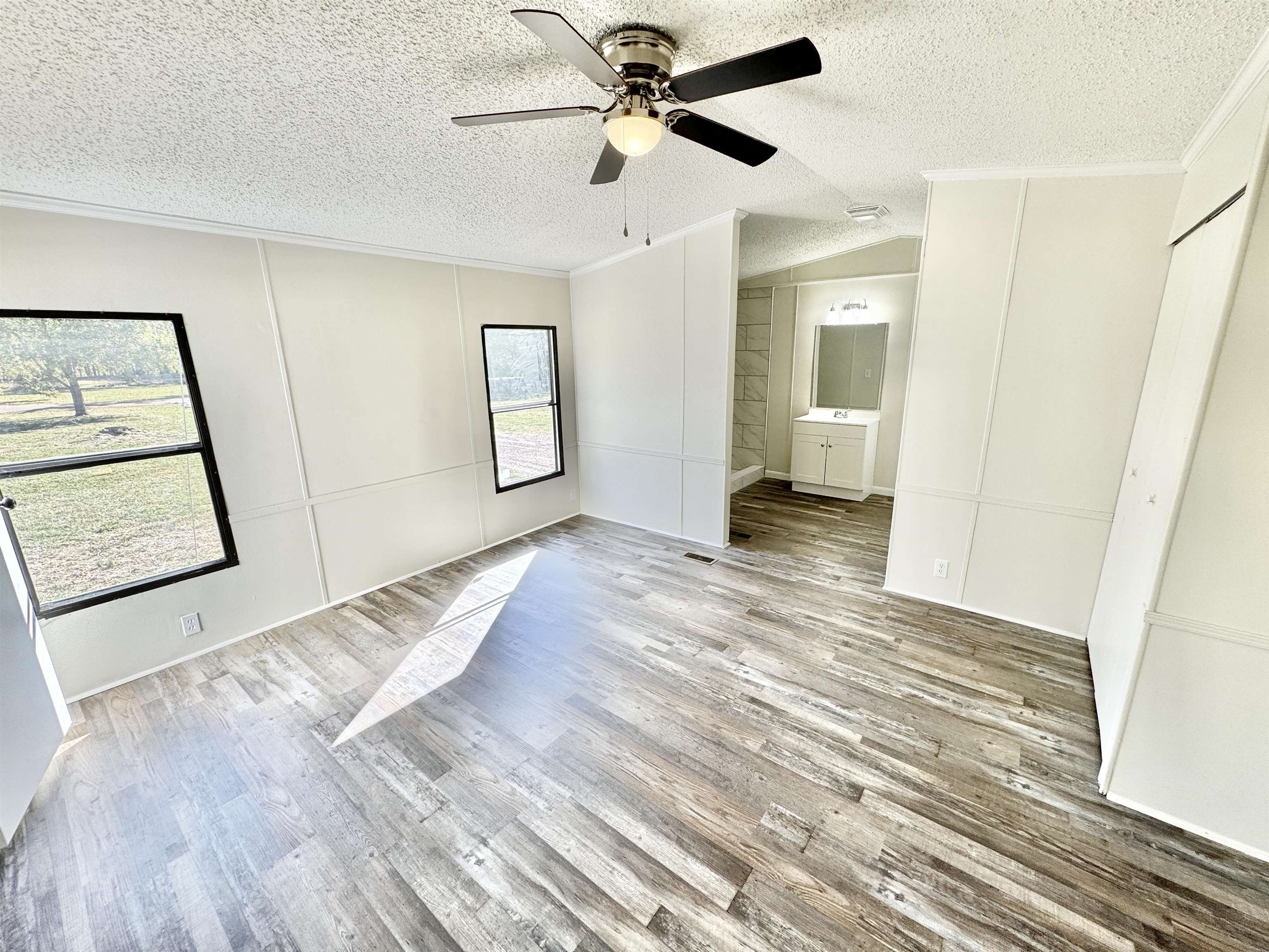 285 Hicks Road Oakland, TN 38060 - Photo 14 of 24 Spare room with lofted ceiling, a textured ceiling, light hardwood / wood-style floors, and ceiling fan