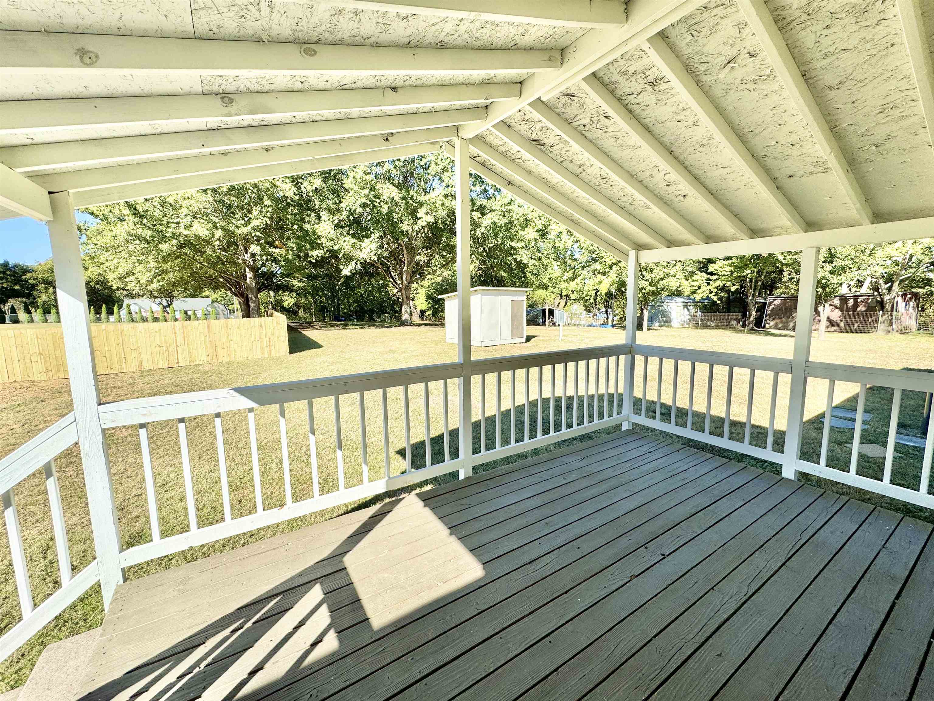 285 Hicks Road Oakland, TN 38060 - Photo 8 of 24 Wooden terrace with a storage unit and a lawn