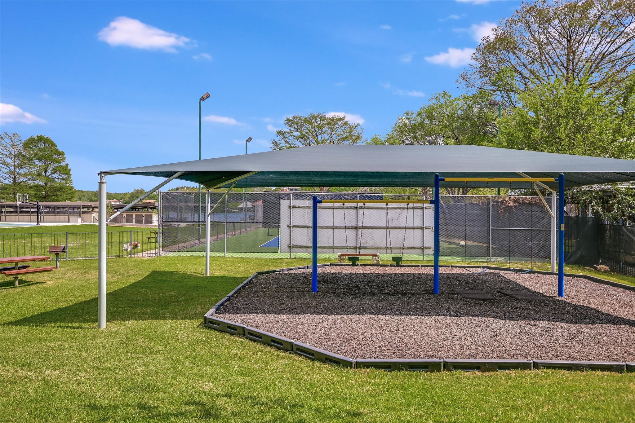 3901 Prentice Lane Austin, TX 78746 - Photo 38 of 40 Covered swings create a peaceful place to unwind while enjoying views of the park and waterfront.