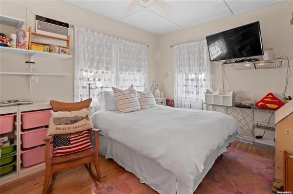 a bedroom with a bed and flat screen tv