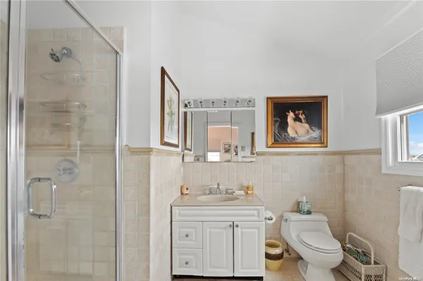 a bathroom with a toilet a sink and mirror