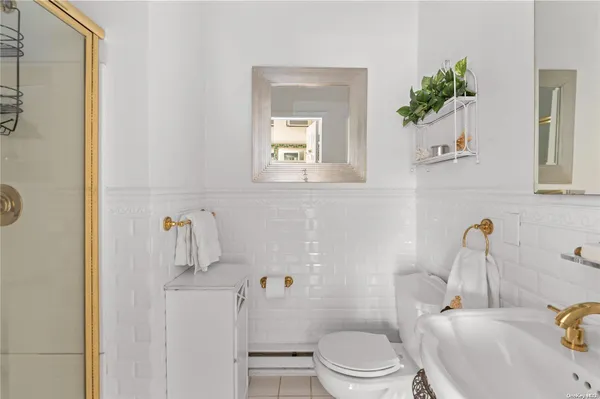 a white toilet sitting next to a bathroom sink