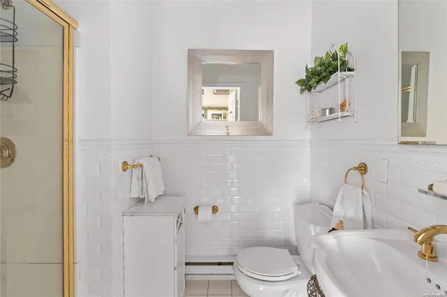 a white toilet sitting next to a bathroom sink