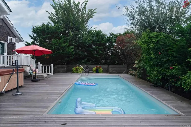 a view of a patio with a table and chairs under an umbrella