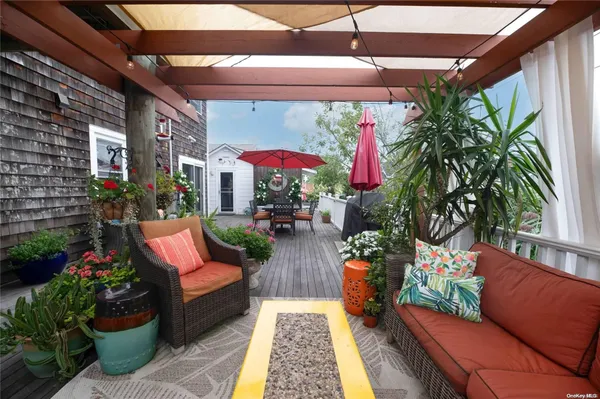 a view of a chairs and tables in patio with a barbeque