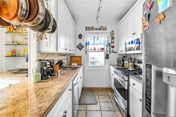 a kitchen with stainless steel appliances granite countertop a sink and cabinets