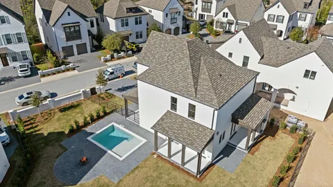 an aerial view of multiple houses with a yard