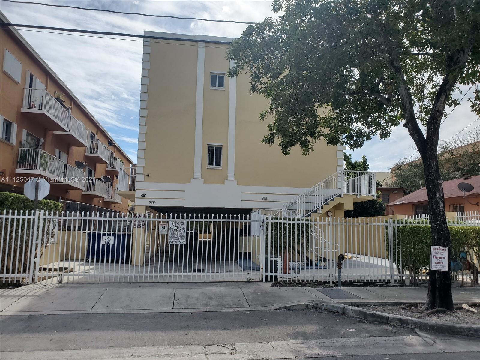 928 Southwest 3rd Street, Unit 203 Miami, FL 33130 - Photo 1 of 16 a view of a brick house with a large trees