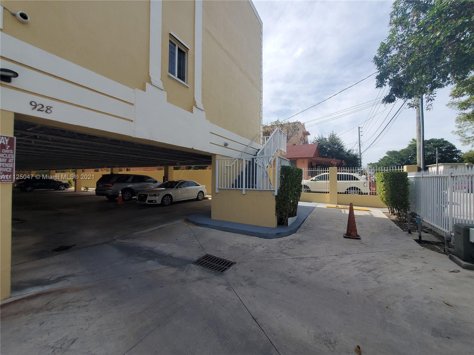 928 Southwest 3rd Street, Unit 203 Miami, FL 33130 - Photo 2 of 16 a view of a cars park in front of a building