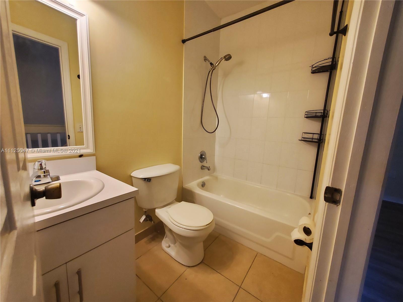928 Southwest 3rd Street, Unit 203 Miami, FL 33130 - Photo 14 of 16 a bathroom with a sink toilet and shower