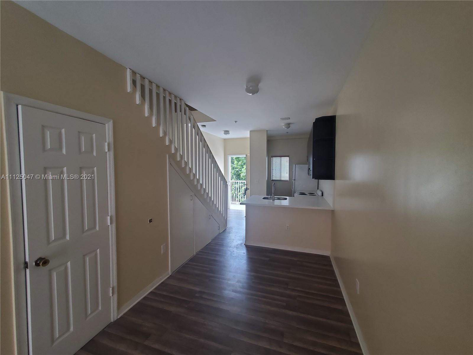 928 Southwest 3rd Street, Unit 203 Miami, FL 33130 - Photo 9 of 16 a view of a kitchen from the hallway