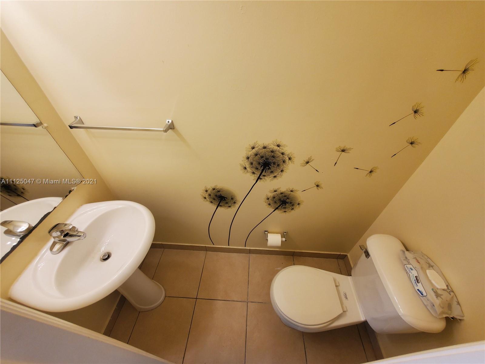 928 Southwest 3rd Street, Unit 203 Miami, FL 33130 - Photo 10 of 16 a bathroom with a toilet sink and mirror