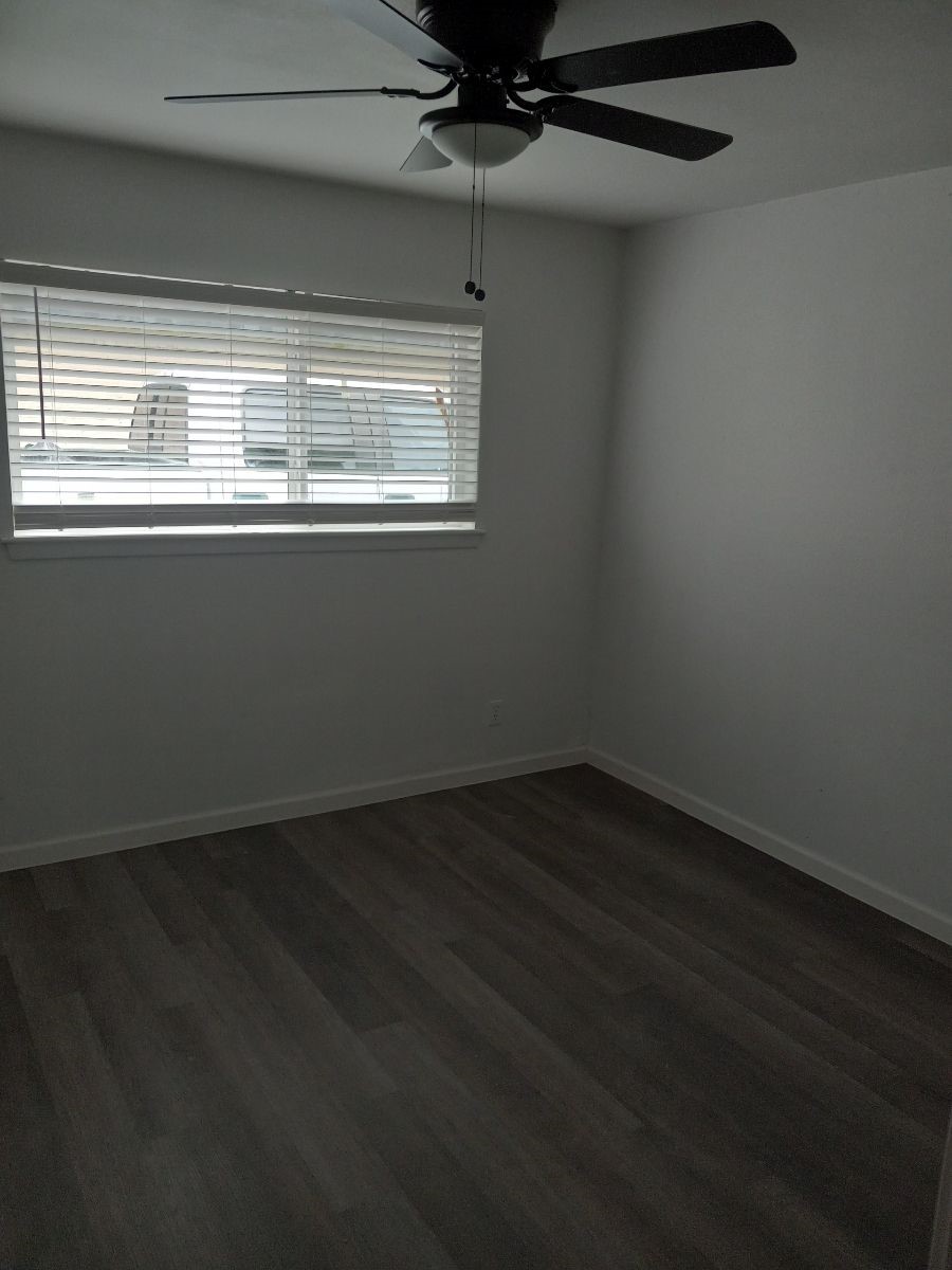 2681 Gessner Road, Unit 402 Houston, TX 77080 - Photo 3 of 11 a view of an empty room with wooden floor and a window